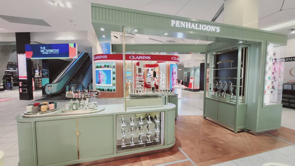 Penhaligon’s fragrance counter with green joinery and brass detailing